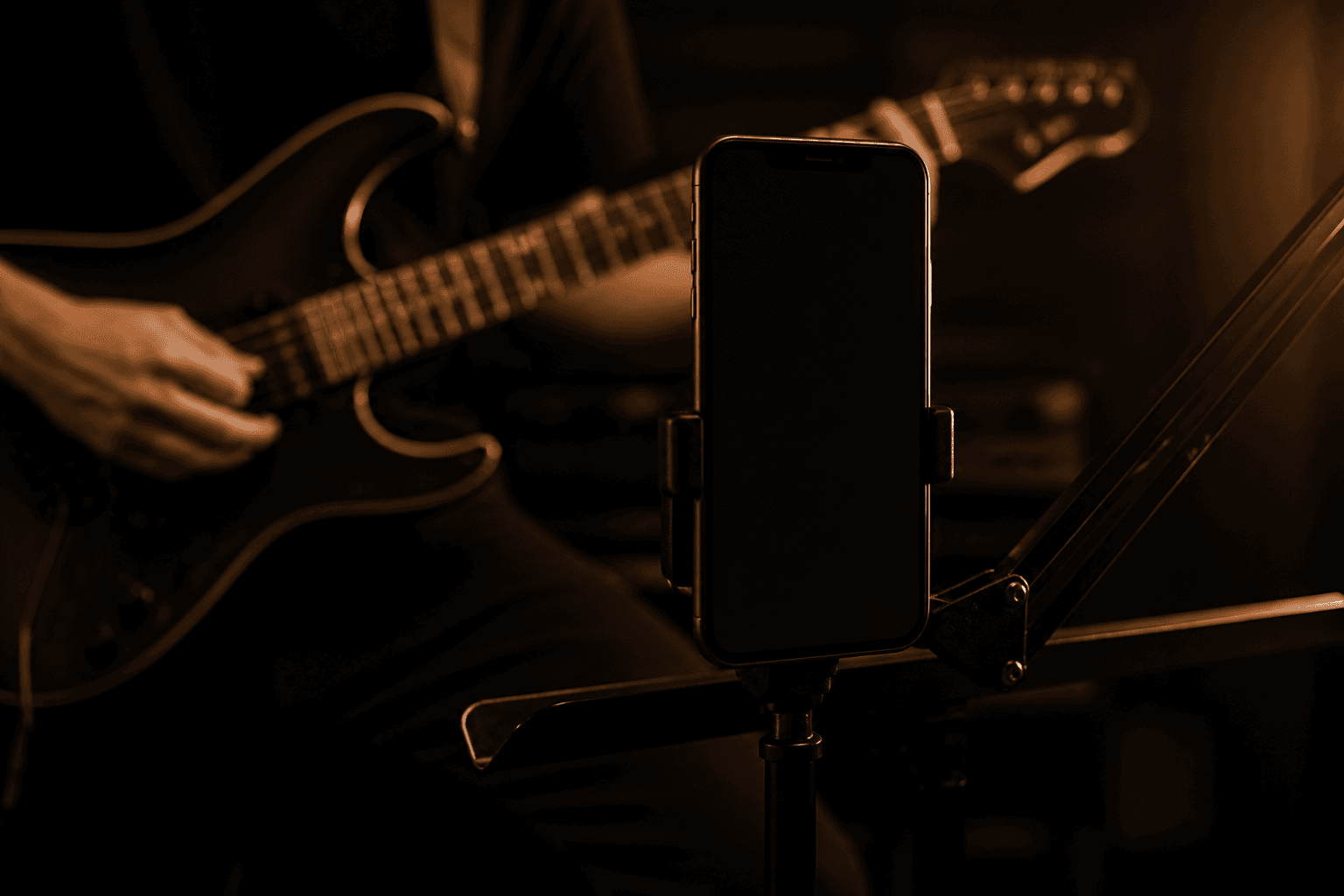 A phone on a stand recording an electric guitar
